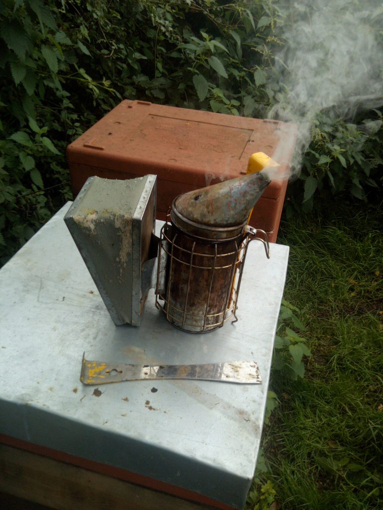 Beehive with a Smoker and Hive Tool