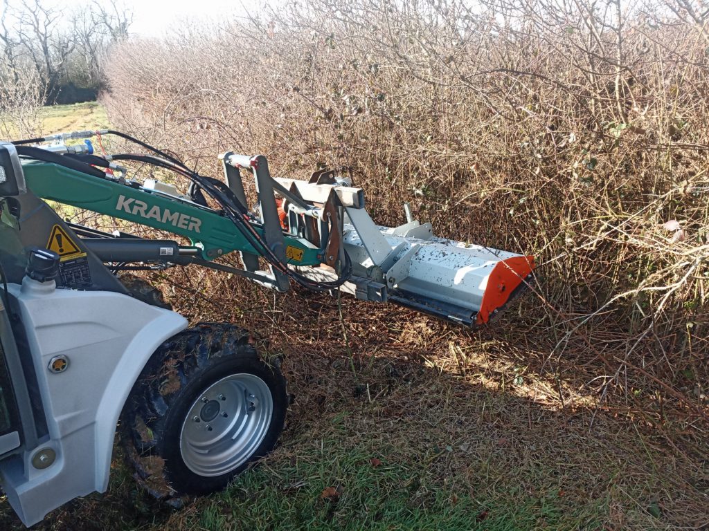 Kramer KL14.5 clearing brush in a new woodland along the drainage ditch